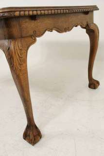 This table has a solid oak base with a walnut veneered top. It is is 