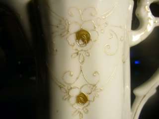  porcelain chocolate pot with raised gold flowers. There are no chips 